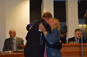 Christopher Parlow receives a hug from Lavallette Council President Anita Zalom at his final meeting with the borough. (Photo: Daniel Nee)