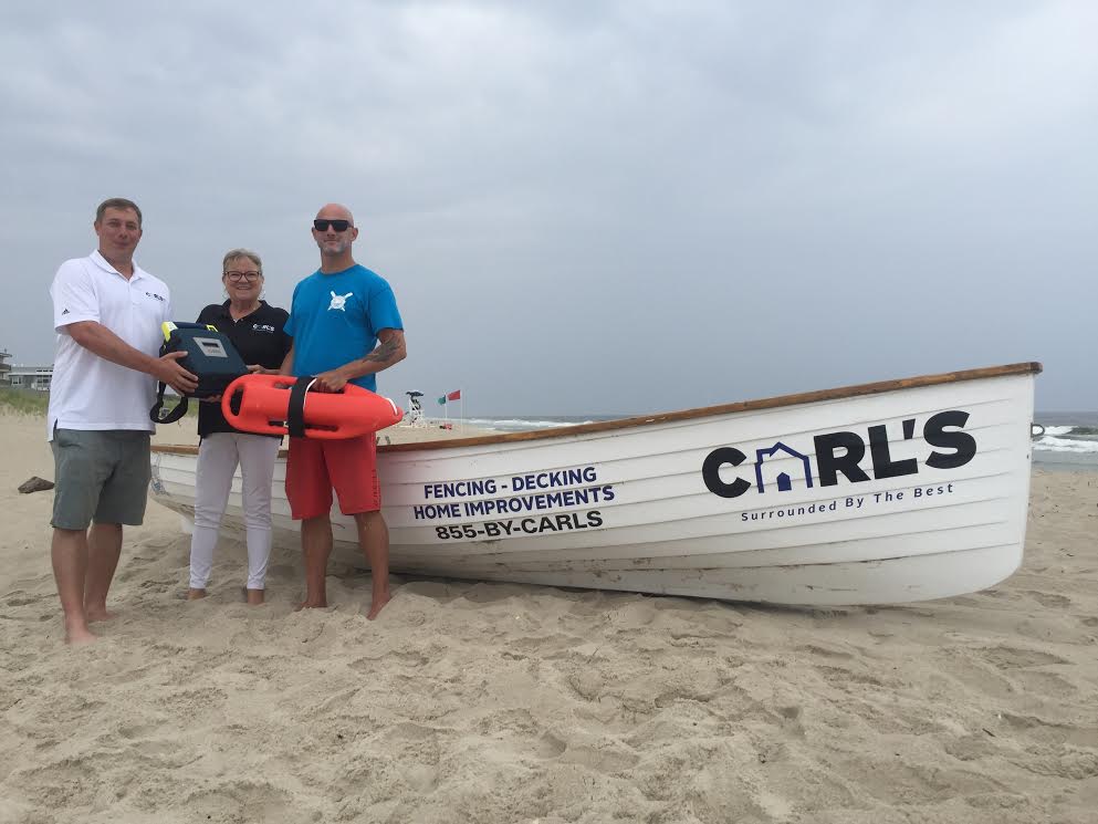 Carl DelPizzo Jr. and Cindy Kuhmann (of Carl’s Fencing, Decking, & Home Improvements) presented Island Beach Motor Lodge, Ocean Lifeguard R.J. Hager with an Automated External Defibrillator