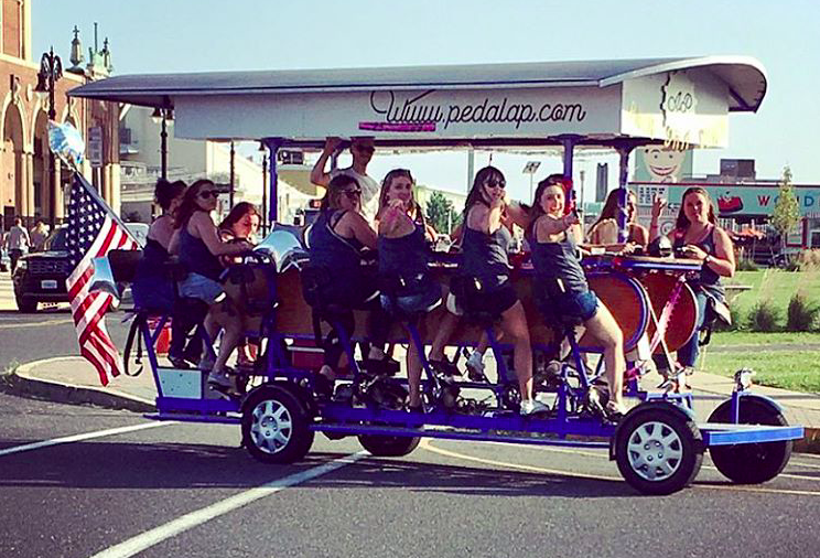 A group on board the Asbury Pedacycle attraction in Asbury Park. (Credit: Asbury Pedacycle/Instagram)