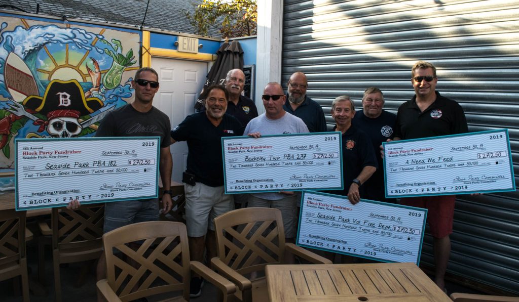 Checks presented to local organizations from the Bum Rogers annual block party, 2019. (Photo: Daniel Nee)