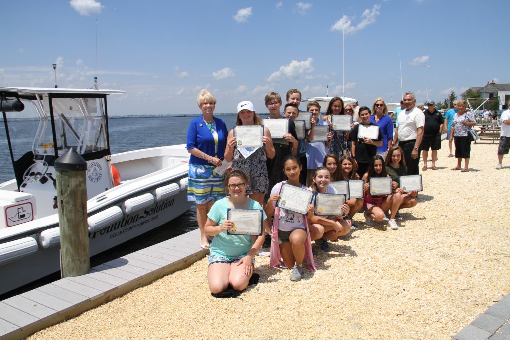 Seventh graders at Lavallette Elementary School, next to the pumpout boat they named. (Photo: Ocean County)