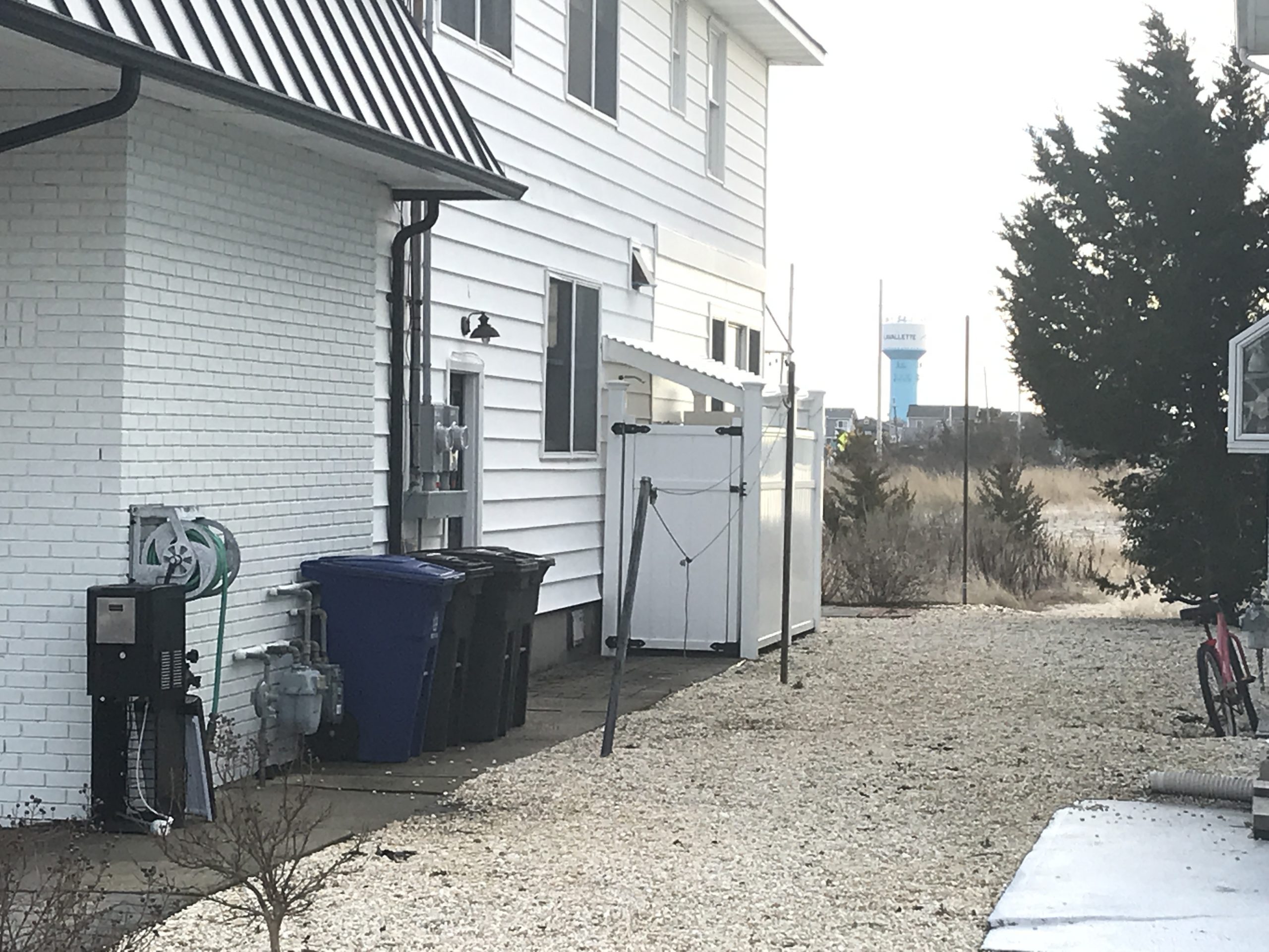 Trash and recycling cans beside a house in Lavallette. (Photo: Daniel Nee)