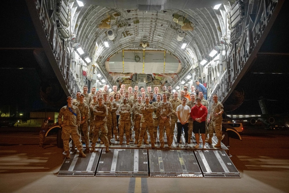U.S. Air Force Airmen from Pope Army Airfield, North Carolina, Joint Base Charleston, South Carolina, and Joint Base McGuire-Dix-Lakehurst, New Jersey, take a moment to pose on a C-17 at Pope AAF Feb. 16, 2022. The team, Task Force Gryphon, operated a 24-hour schedule to coordinate the transportation and delivery of personnel and cargo to Poland and Germany in the United States steadfast commitment to Ukraine’s sovereignty and territorial integrity in support of a secure and prosperous Ukraine. (U.S. Air Force photo/Staff Sgt. Katelynn Thomas)