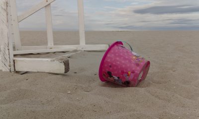 A beach sand pail next to a lifeguard chair in Seaside Heights, N.J., July 2022. (Photo: Daniel Nee)