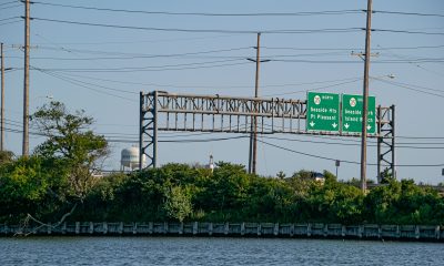 Highway signs entering the barrier island from the Route 37 bridge. (Photo: Daniel Nee)