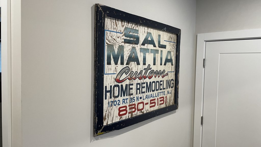 A historical sign from Mattia Builders hanging in the company's new office, March 2023. (Photo: Daniel Nee)