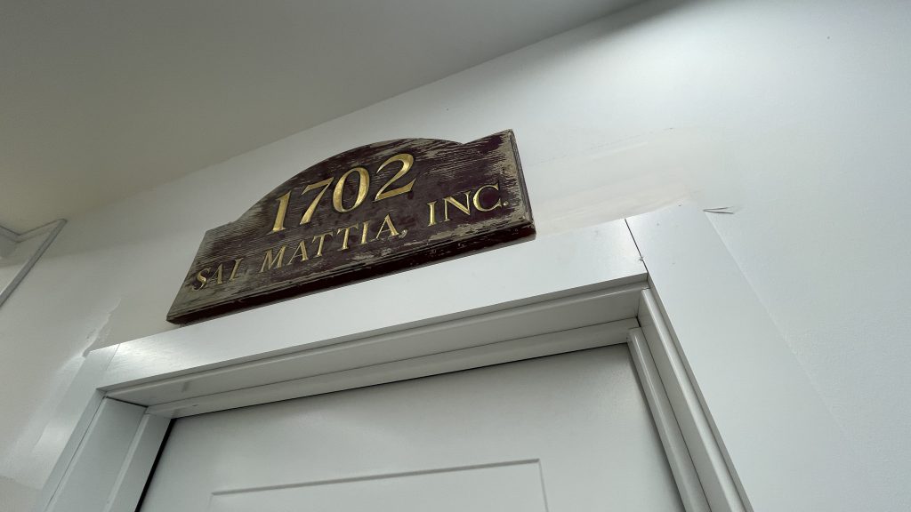 A historical sign from Mattia Builders hanging in the company's new office, March 2023. (Photo: Daniel Nee)