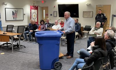 A representative from IPL Global shows off his company's tipper can (robo-can) for garbage collection, March 2023. (Photo: Daniel Nee)