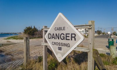 A cable crossing sign remains at the site of a de-energized transmission line in Seaside Park which is planned to be replaced in 2023. (Photo: Shorebeat)