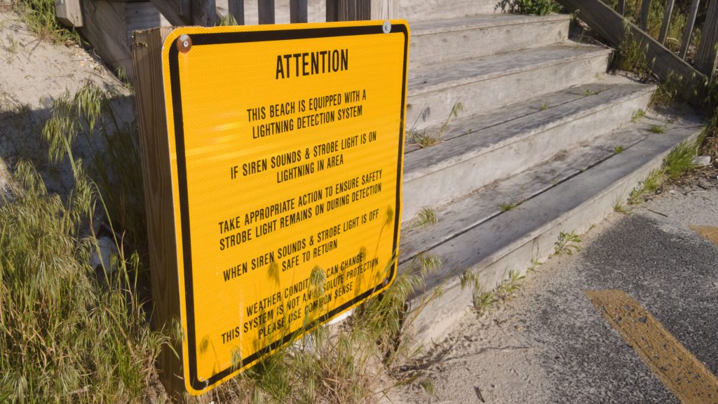 A sign advising beachgoers of Toms River's lightning detection system at a beach entrance in Ortley Beach. (Photo: Shorebeat)