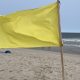 A single-yellow flag flies at Brick Beach III, Aug. 2023. (Photo: Shorebeat)