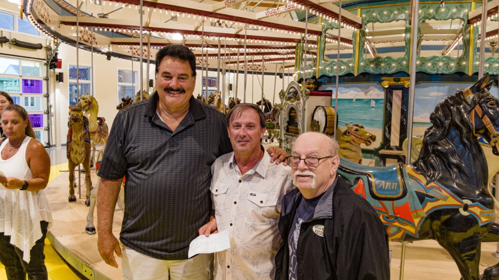 Members of the Seaside Heights Property Owners Association present a donation to Borough Administrator Christopher Vaz to go toward the carousel restoration project, Aug. 2023. (Photo: Shorebeat)