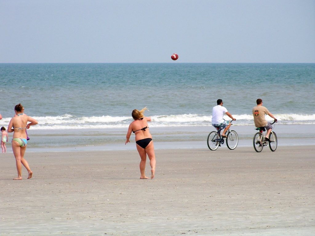 Beachgoers play soccer near the water. (Source: Jon Dawson/Creative Commons/Flickr)